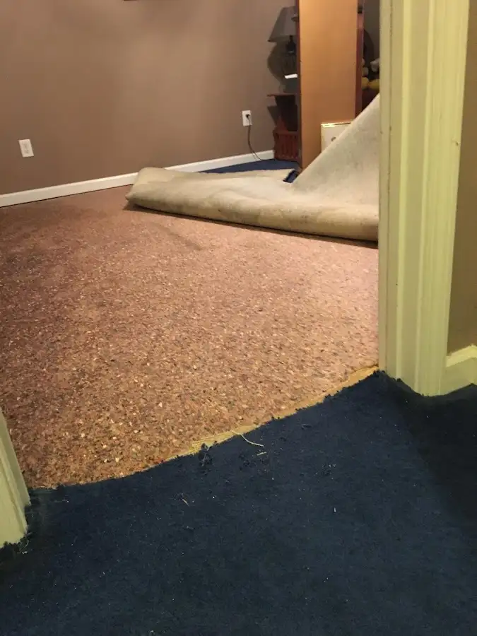 Carpet pad removal revealing water damage during Water Mitigation Services in Rockcreek